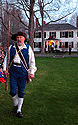 A minuteman walking in front of one of the two houses right on the Green; that house was having quite a party.  When the battle started there were maybe 20 people sitting on it's rooves and porches.