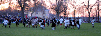 The minutemen begin to assemble on the green.  Captain Parker will come out of Buckman's Tavern, in the background, and get them in better order shortly.