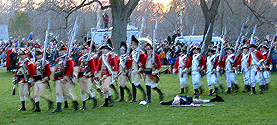 The grenadiers march past the body.