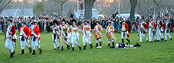 The band marches past the body.