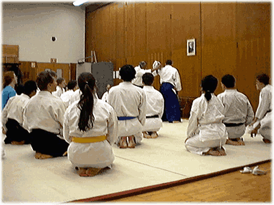 The class watches as sensei demonstrates shihonage