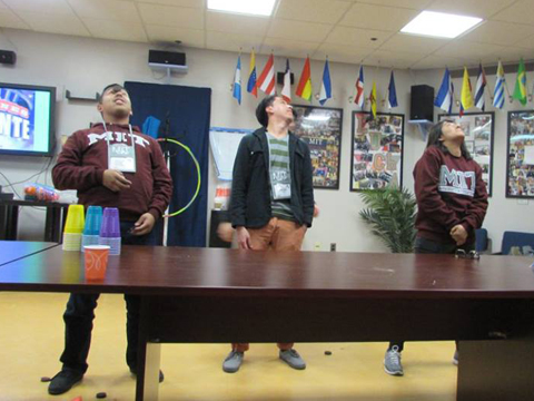 3 prosceptive MIT students playing a game